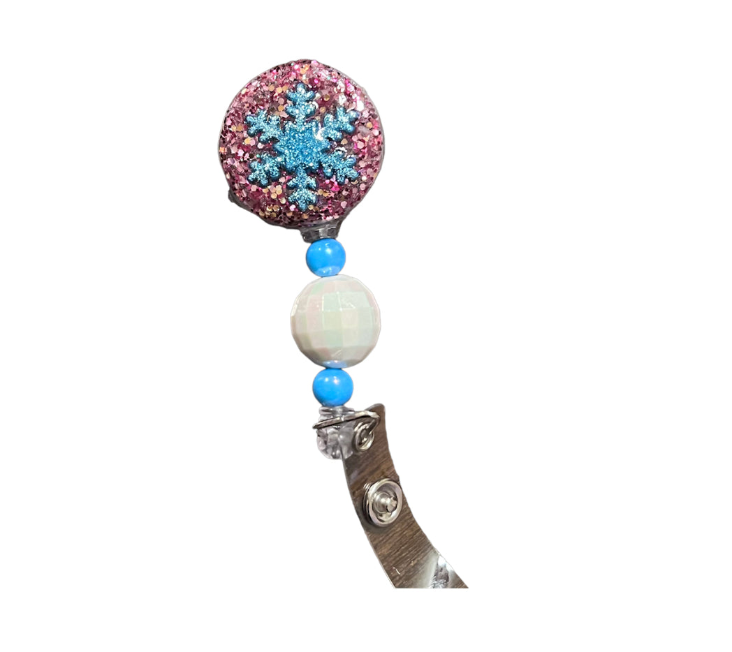 (G) Pink and blue snowflake badge reel