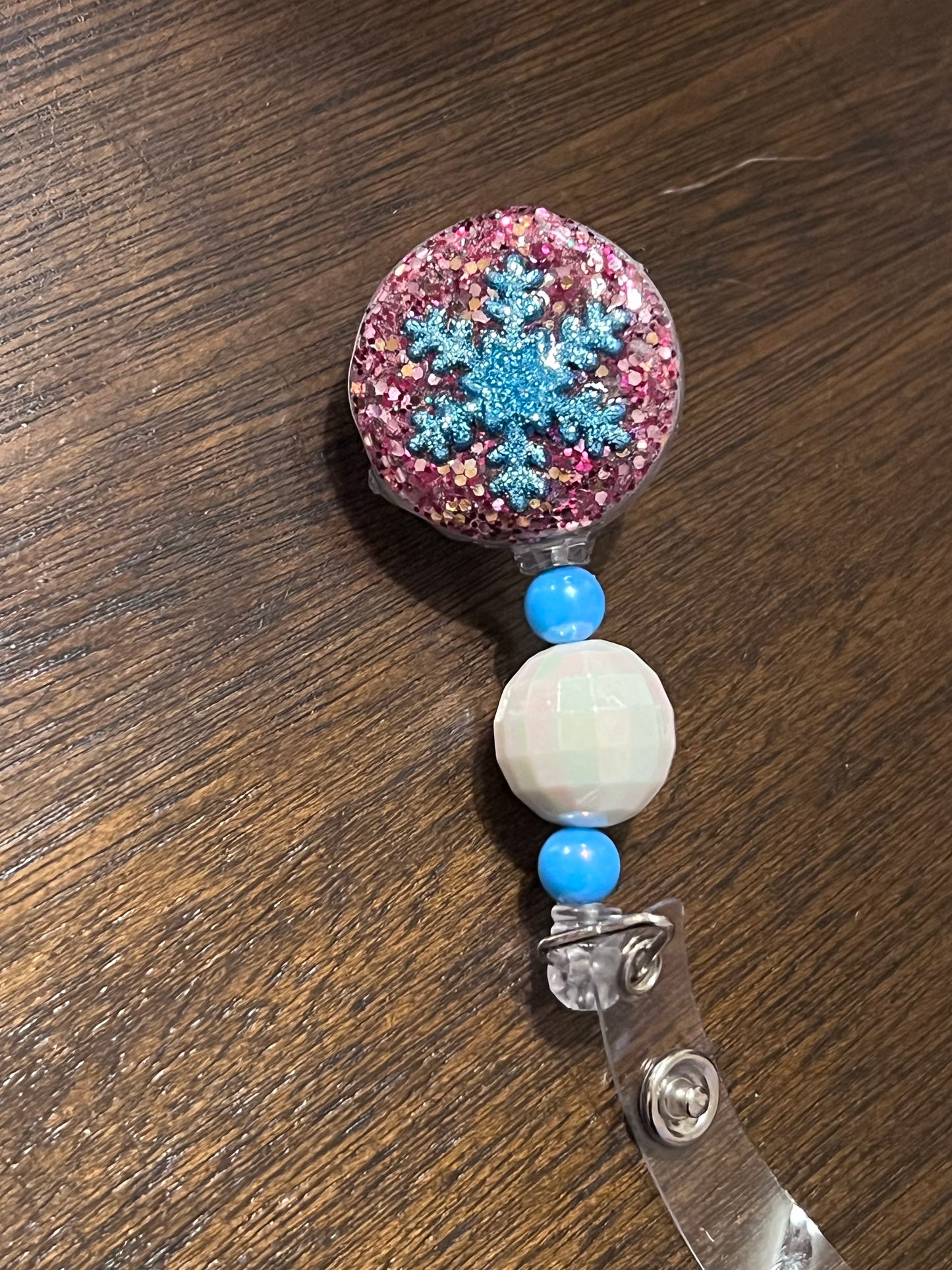 (G) Pink and blue snowflake badge reel