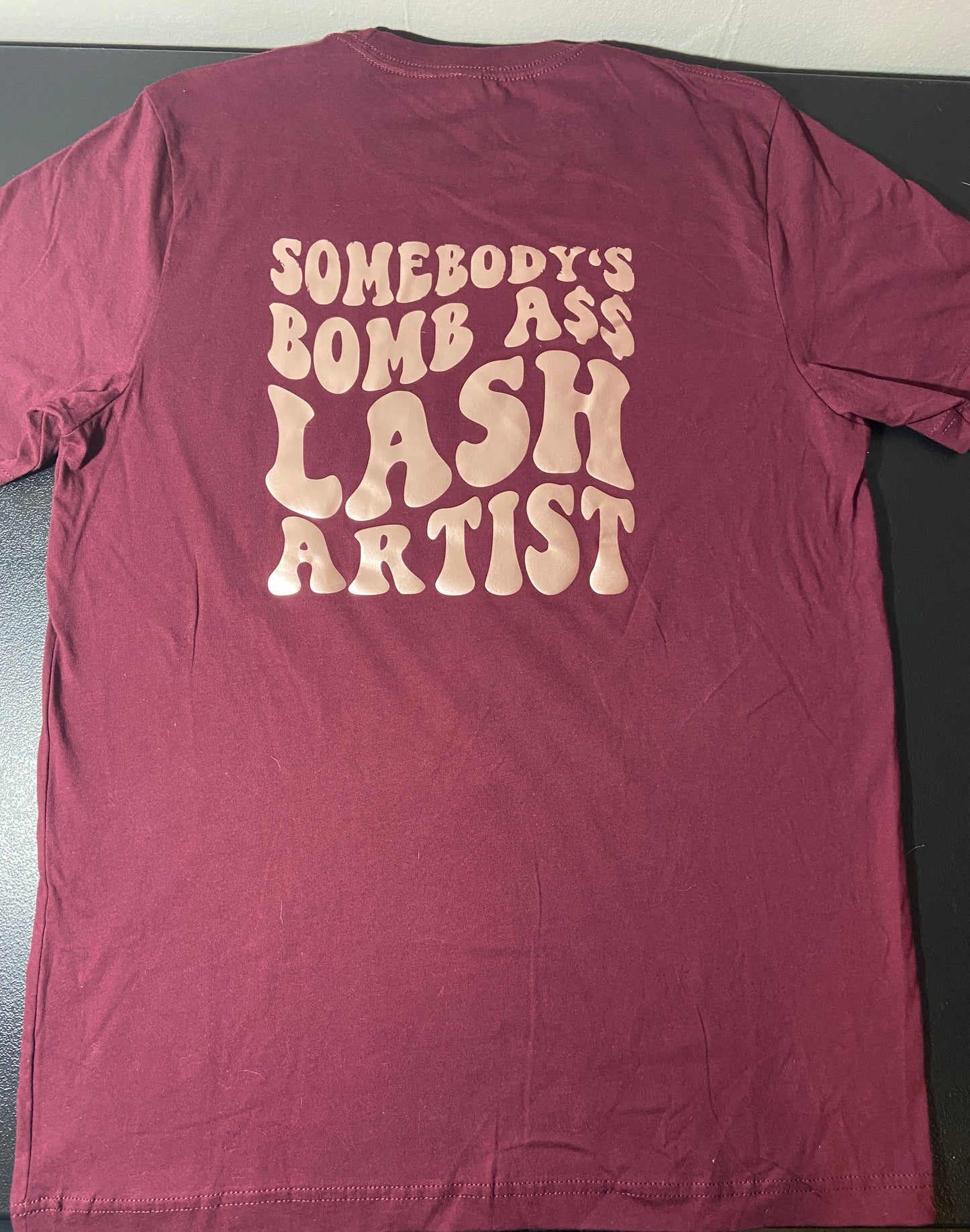 (A) Somebody's Bomb Ass Lash Artist t-shirt